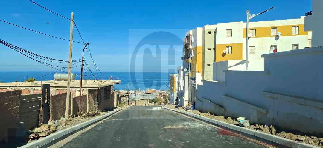 تهيئة وتزفيت الطّريق الرّابط بين متوسّطة منادي عبد القادر وأحياء 100/80/116 مسكن أعالي المهام بشرشال